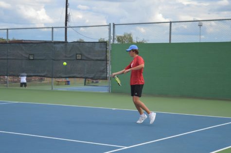 Junior Troy Kneese gets ready to hit a forehand against Kerrville Tivy.