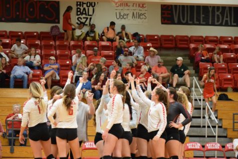 The Billie volleyball team breaks out of their time-out huddle during the Canyon Lake game.