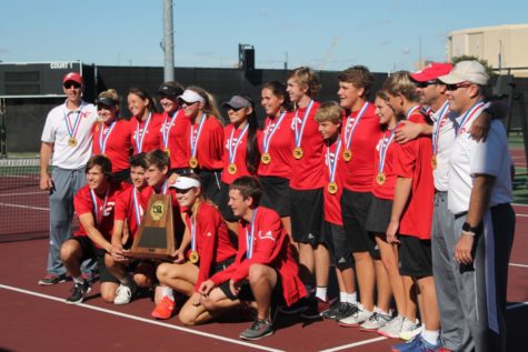 The varsity tennis team poses with their plaque after winning the 4a state team tennis title.