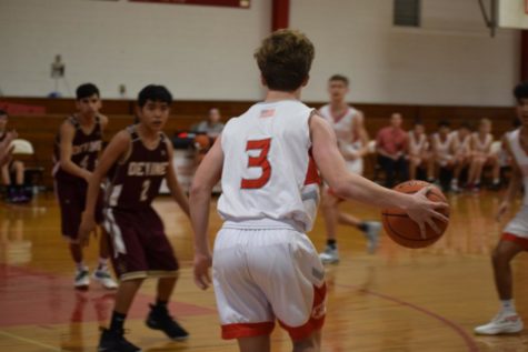 Judson Beard scans the floor for the open man against Devine.