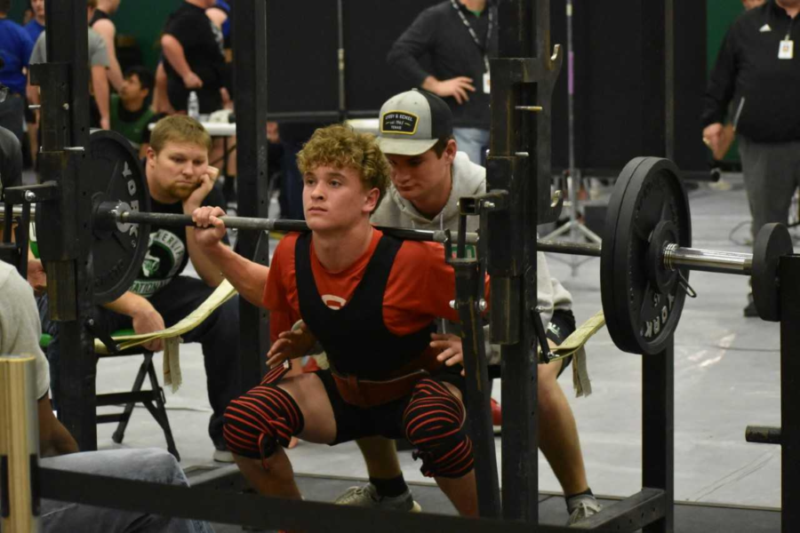 Freshman John Tewksbury squats during the Lago Vista meet. 