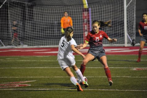 Harley Wilferth, recently concussed, stops a Taylor-forward from shooting.