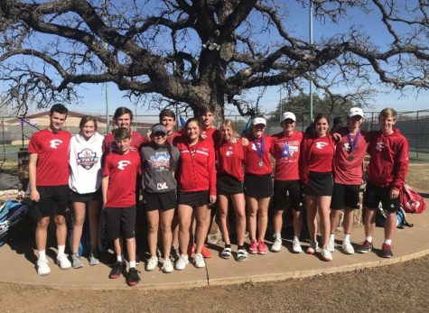 The varsity tennis team stands for a picture after their tournament.