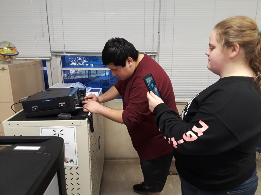 Members of the newly formed radio club work with the equipment to be able to communicate with others.