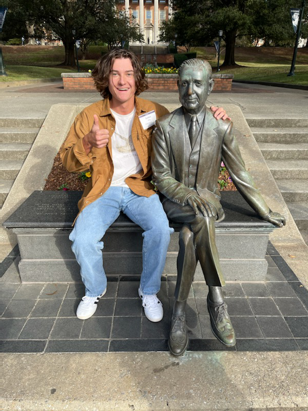 Sutton+King+poses+with+a+statue+of+Ralph+W.+Beeson+at+Samford+University+in+Birmingham%2C+Alabama.+It+is+a+tradition+to+sit+next+to+him+and+take+a+photo+when+you+visit+the+university.